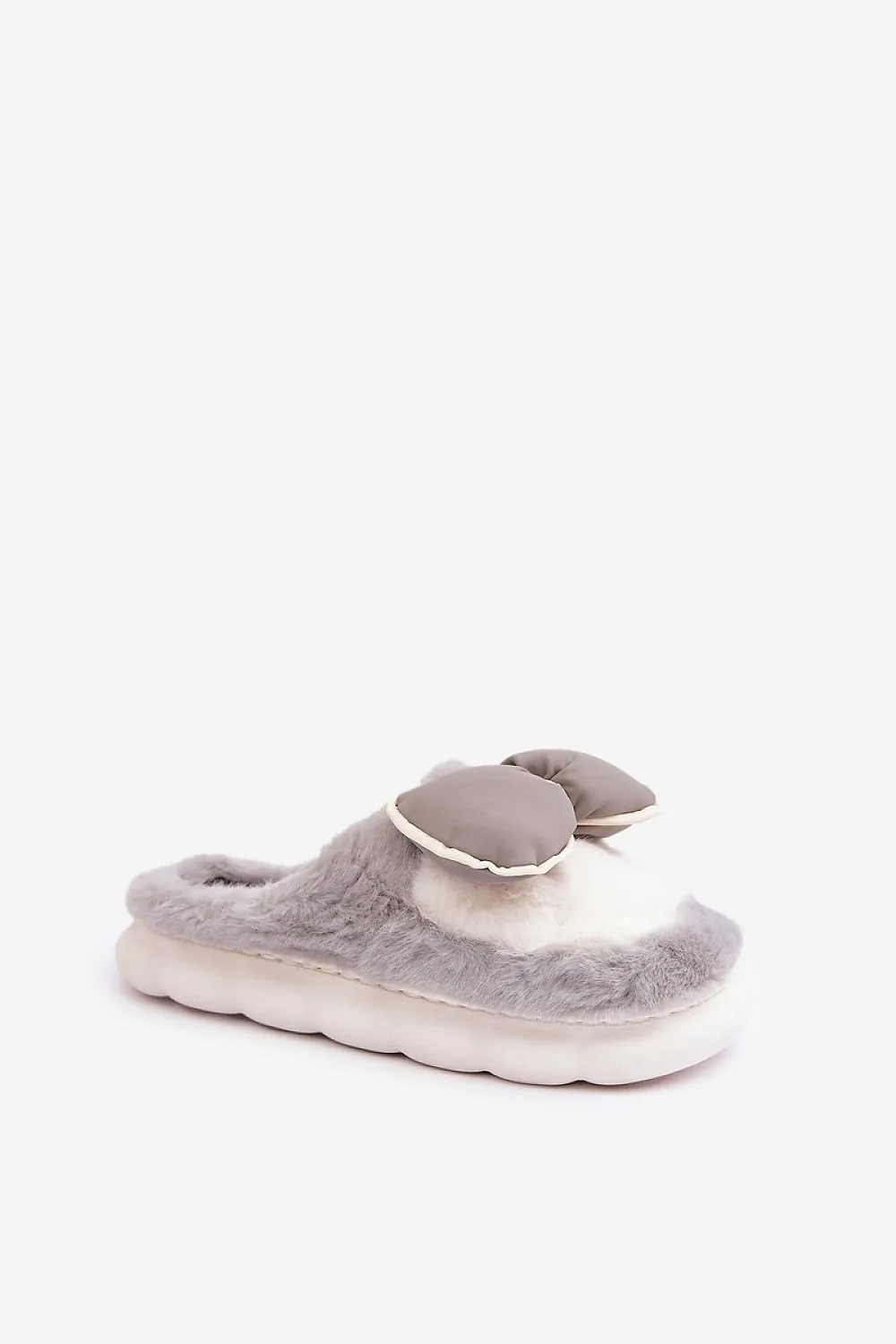 Soft cozy fur slippers decorated with a bow