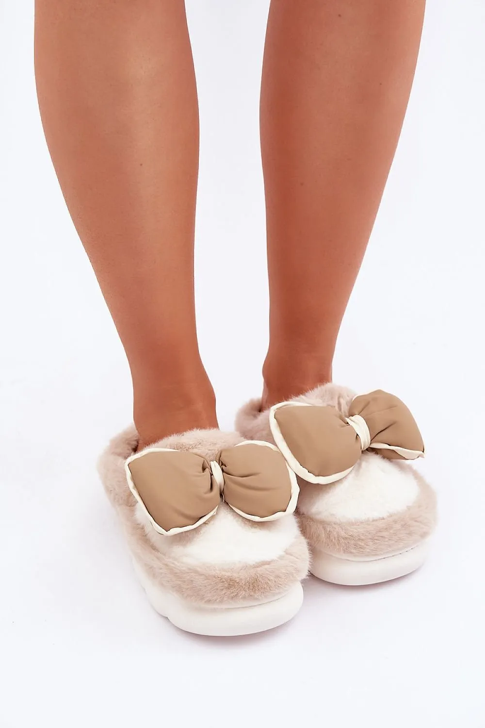 Soft cozy fur slippers decorated with a bow