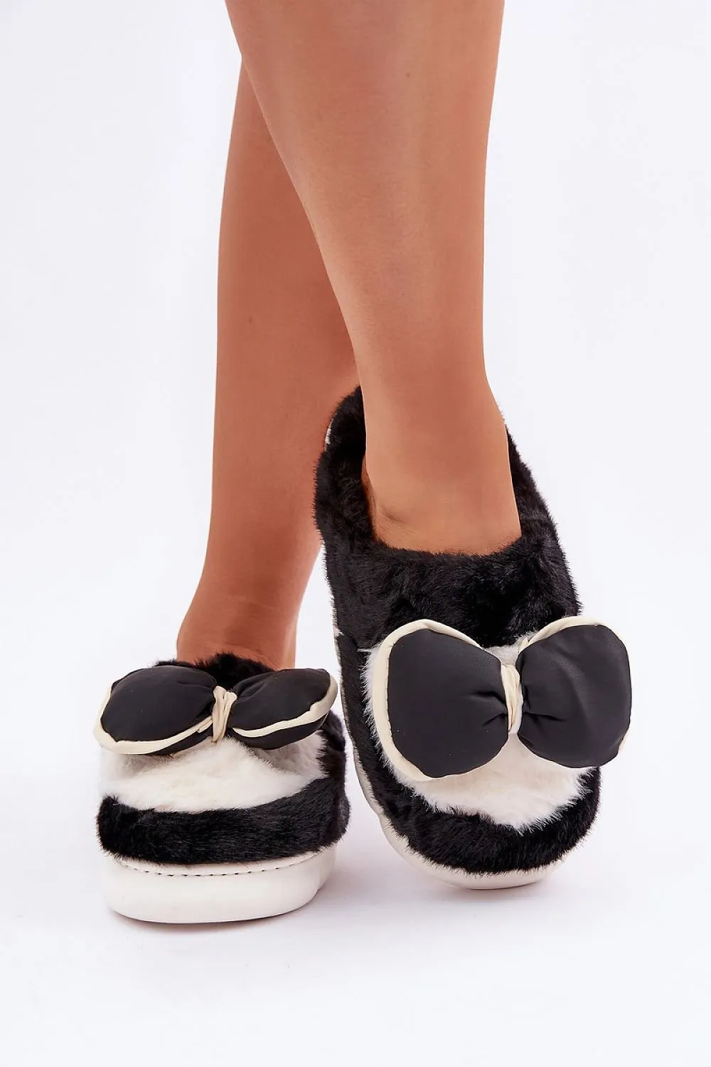 Soft cozy fur slippers decorated with a bow